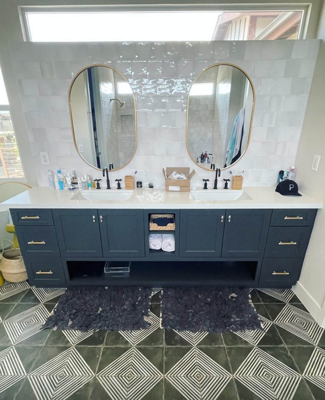 Navy double vanity with brass mirrors