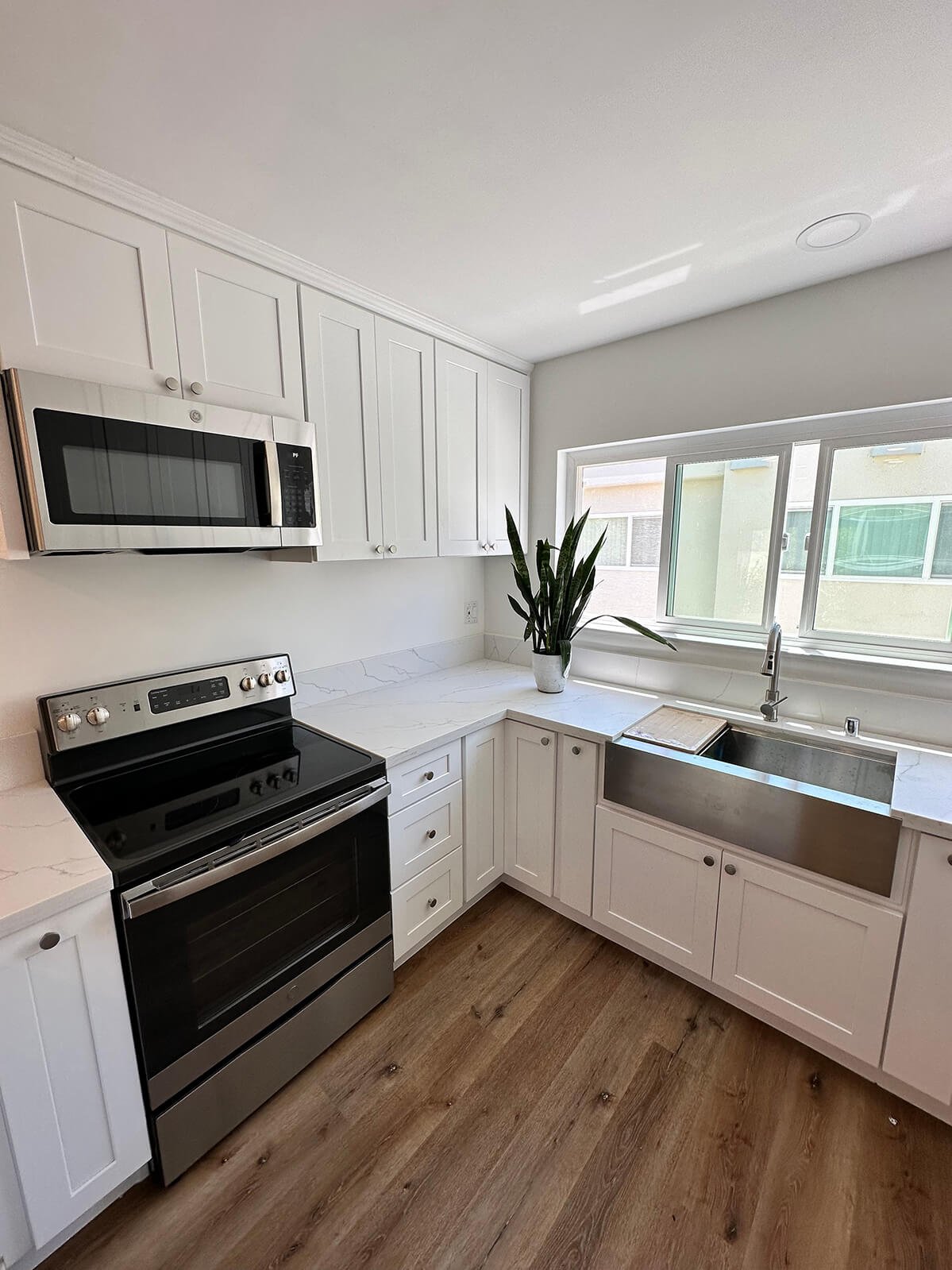 White kitchen remodel with farmhouse sink