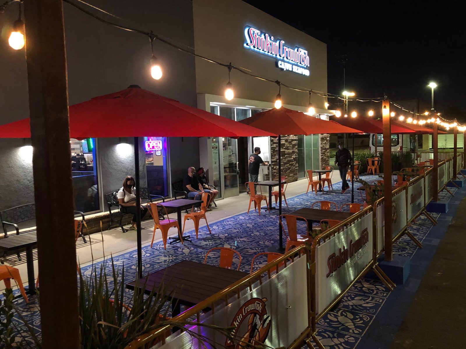 Restaurant patio dining at night with string lights