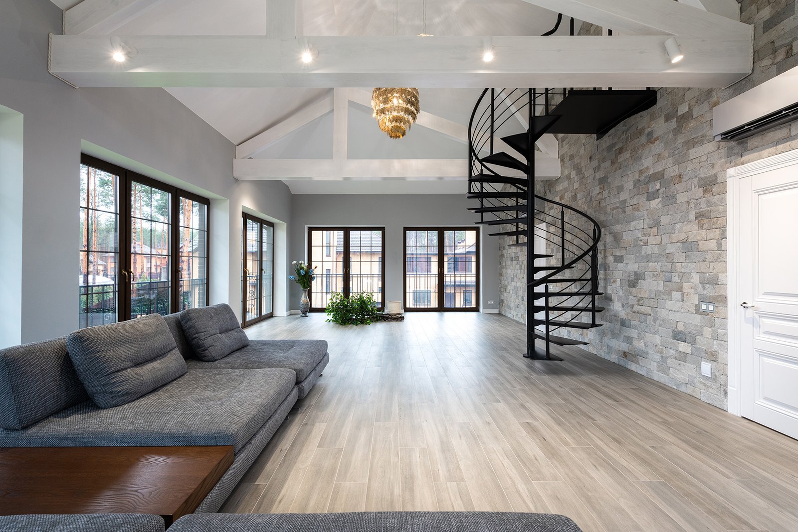 Vaulted-ceiling living room renovation with stone accent wall