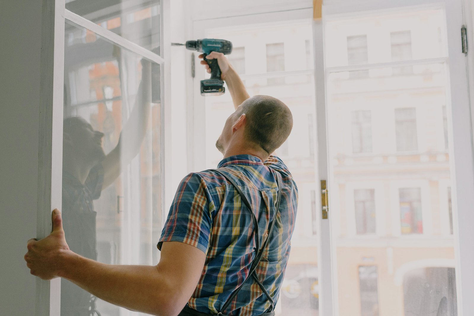 Crew member installing a window
